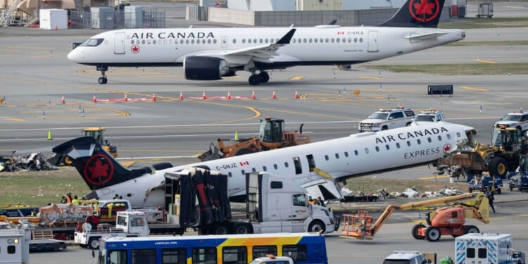 Mangled plane in LaGuardia crash is towed from runway as most injured passengers leave hospital