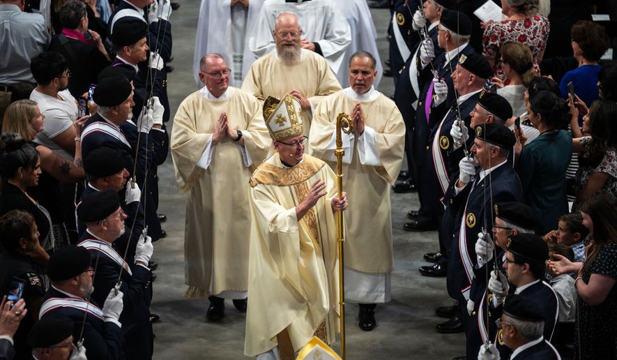 The processional makes its way down the center aisle at the National Western Center at the conclusion of a rite of installation for the new Archbishop James Golka, front center, Wednesday, March 25, 2026, in Denver. (Stephen Swofford/The Gazette via AP)