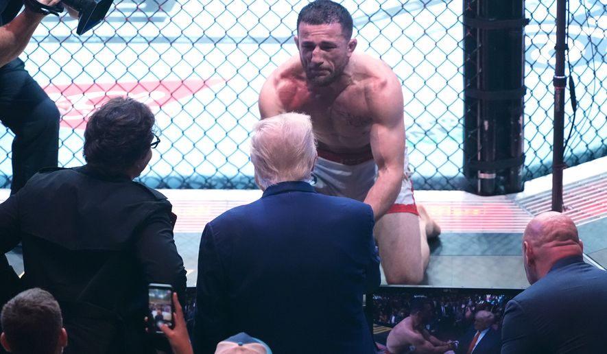President Donald Trump congratulates Georgia's Merab Dvalishvili, after he won his bantamweight title bout against Sean O'Malley, during the UFC-316 mixed martial arts event, at the Prudential Center, June 7, 2025, in Newark, N.J. (AP Photo/Manuel Ceneta, File)