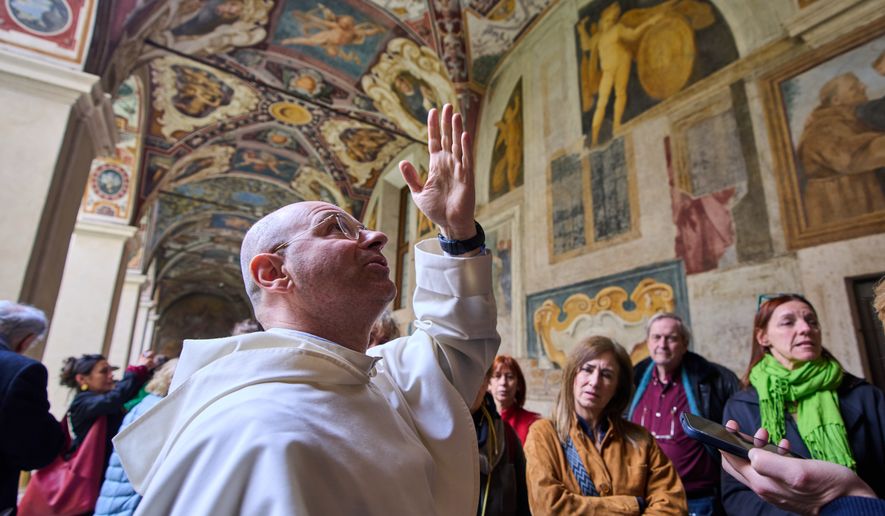 Friar Daniele Aucone, foreground, deputy director of the Basilica of Santa Maria sopra Minerva, guides journalists through the basilica’s cloister in Rome, Wednesday, March 18, 2026. (AP Photo/Domenico Stinellis)