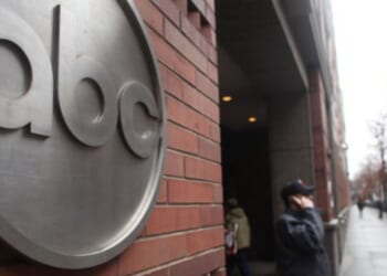 People walk by the ABC Headquarters in Atlanta, Georgia, on Feb. 24, 2010