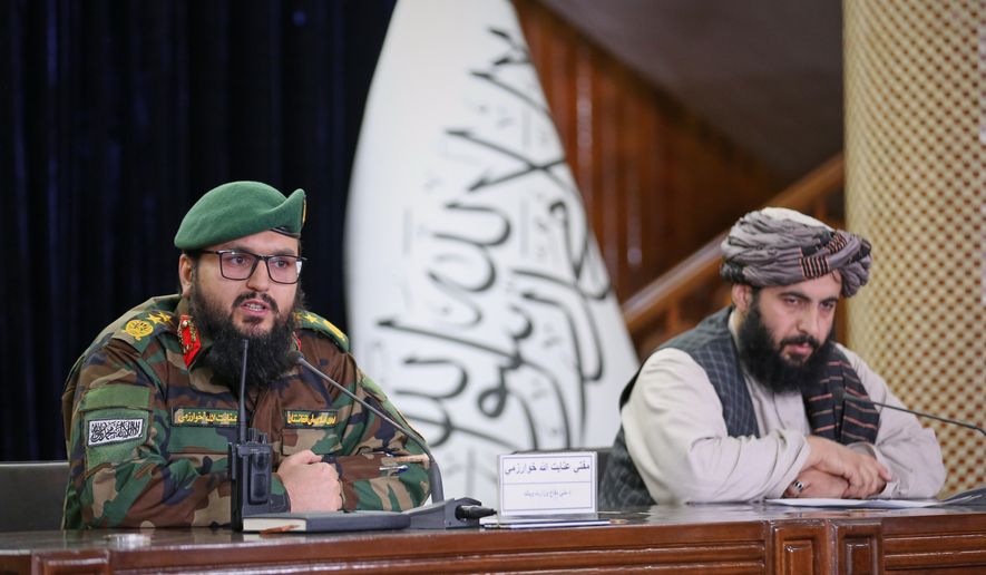 Enayatullah Khowarazmi, left, spokesman of the Defence Ministry, and Hamdullah Fitrat, deputy spokesman for the Islamic Emirate of Afghanistan, speak during a press conference in Kabul, Afghanistan, on Tuesday, March 3, 2026. (AP Photo/Siddiqullah Alizai)