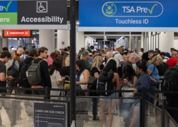 Travelers wait in a TSA pre-check security line at Miami International Airport in Miami, Florida. Travelers across the country are enduring long airport security lines as a partial federal government shutdown affects Transportation Security Administration officers, who recently received $0 paychecks.