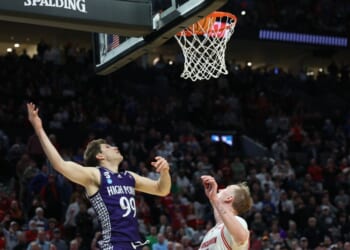 High Point guard Chase Johnston (99) watches his 2-point shot go in the basket during the final seconds of the second half in the first round of the NCAA college basketball tournament against Wisconsin, Thursday in Portland, Ore. The shot put High Point ahead of Wisconsin.