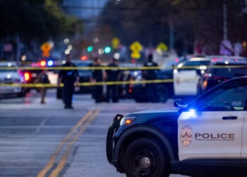 Police patrol the intersection near where three people were killed and 14 others hospitalized during a mass shooting at Buford's bar in downtown Austin, Texas, on March 1, 2026.