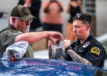 Police bag magazines of ammunition after arresting a man outside of a watch party for GOP Texas Senate Candidate Ken Paxton on March 3, 2026 in Dallas, Texas. Paxton is facing off against numerous candidates including incumbent Senator John Cornyn in the Republican Senate primary.