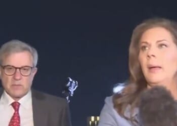 CNN's Erin Burnett, right, heads for cover with Dan Diker, president of the Jerusalem Center for Public Affairs, left, after air raid sirens went off in Tel Aviv, Israel.