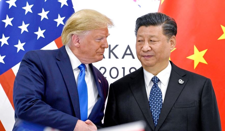 President Donald Trump, left, shakes hands with China's President Xi Jinping during a meeting on the sidelines of the G-20 summit in Osaka, Japan, June 29, 2019. (AP Photo/Susan Walsh, File)