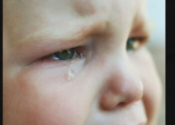 A stock image shows a close-up of a baby crying. A Virginia couple was horrified when they checked surveillance video after their babysitter made an offhand remark.