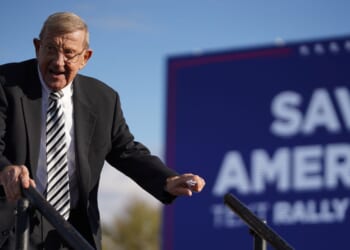Lou Holtz leaves the stage during a rally with President Donald Trump at the Florence Regional Airport on March 12, 2022, in Florence, South Carolina.
