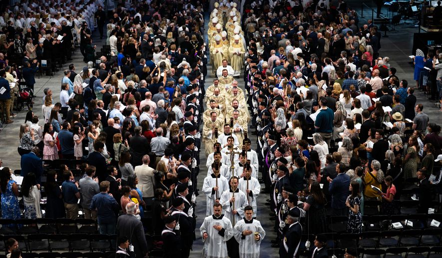 The processional makes its way down the center aisle at the National Western Center at the conclusion of a rite of installation for the new Archbishop James Golka Wednesday, March 25, 2026, in Denver. (Stephen Swofford/The Gazette via AP)