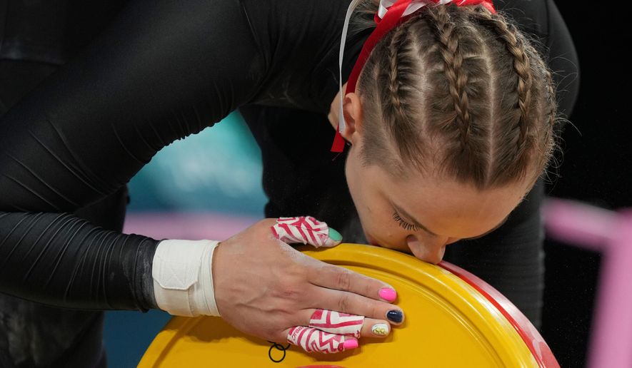 Weronika Zielinska of Poland kisses the weight as she competes during the women's 81kg weightlifting event, at the 2024 Summer Olympics, Saturday, Aug. 10, 2024, in Paris, France. (AP Photo/Kin Cheung,File)
