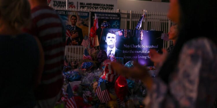 A large shrine made up of flowers, balloons, and U.S. flags displayed in honor of conservative Turning Point USA founder Charlie Kirk in Phoenix, Arizona, on Sept. 19, 2025.