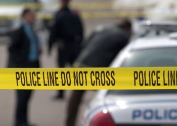 Police tape cordons off a crime scene.