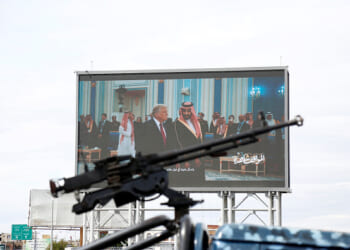 Houthis-mounted machine gun across from screen of Donald Trump meeting with Middle Eastern leaders.