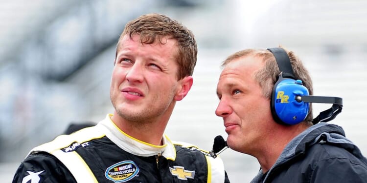 Chase Pistone, left, talks with a crew member during practice for the NASCAR Camping World Truck Series Kroger 250 at Martinsville Speedway on March 28, 2014, in Martinsville, Virginia.