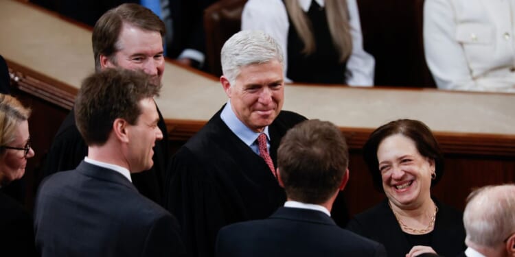 Supreme Court Associate Justices Brett Kavanaugh, Neil Gorsuch, and Elena Kagan arrive for President Joe Biden's State of the Union address during a joint meeting of Congress in the House chamber at the U.S. Capitol on March 7, 2024, in Washington, D.C.