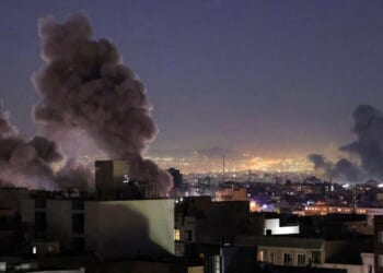 Smoke plumes rise over Tehran following missile strikes from both the United States and Israel's militaries on March 1, 2026.