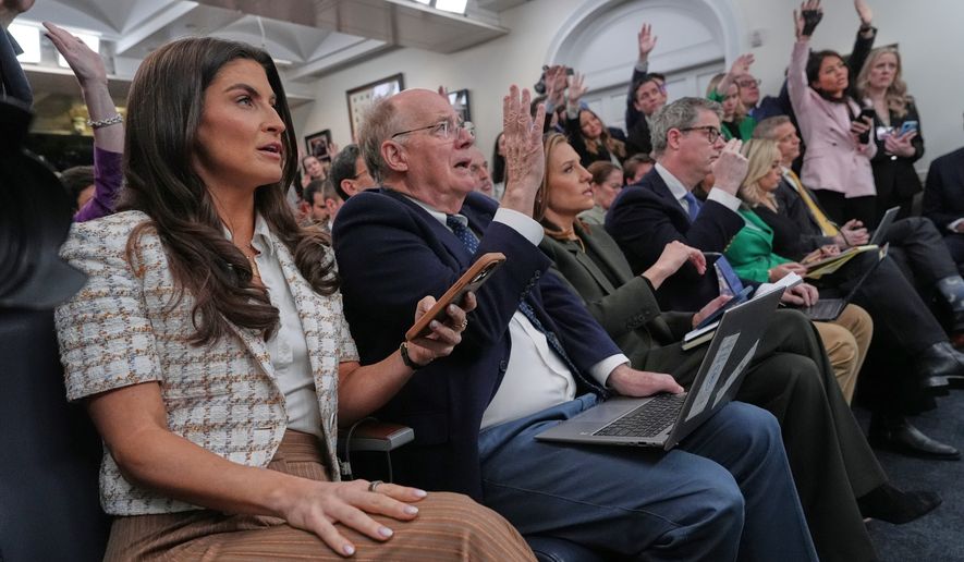 Reporters raise their hands to ask questions in the James Brady Press Briefing Room as White House press secretary Karoline Leavitt speaks at the White House, Wednesday, March 4, 2026, in Washington. (AP Photo/Jacquelyn Martin)