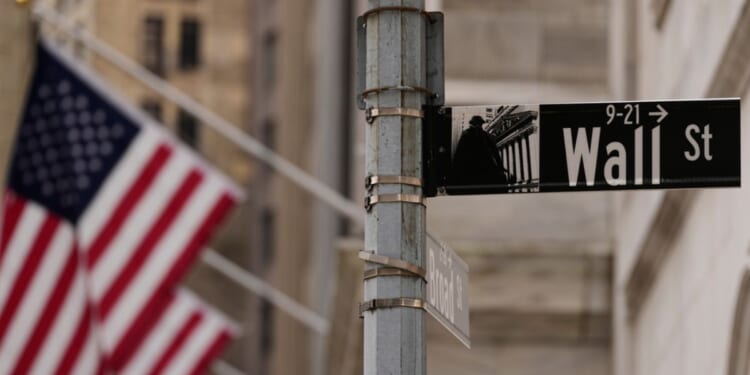 A Wall Street sign is seen outside of the New York Stock Exchange in New York, Monday.