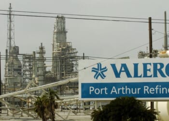 Damage to supply pipes and a sign are seen at the idle Valero oil refinery on Sept. 25, 2005, in Port Arthur, Texas, in the aftermath of Hurricane Rita.