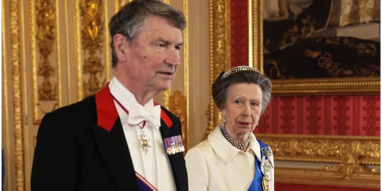 Vice Admiral Sir Tim Laurence and Princess Anne, sister of King Charles III, attend the state banquet for President of Nigeria Bola Ahmed Tinubu and First Lady Oluremi Tinubu at Windsor Castle, Berkshire, on Wednesday in Windsor, England. Anne wore a white ensemble that she first wore in public in 1969.