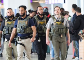 Immigration and Customs Enforcement agents walk through LaGuardia Airport in New York on March 23, 2026.