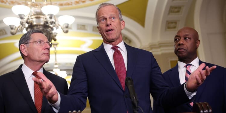 U.S. Senate Majority Leader John Thune of South Dakota , joined by his fellow Republicans Sen. John Barrasso of Wyoming, left, and Sen. Tim Scott of South Carolina, speaks to reporters March 3 following the weekly Senate Republican policy luncheon at the U.S. Capitol. Thune angered conservatives Monday with his latest excuse for not pushing to pass the SAVE America Act.