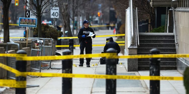Toronto Police officers work around the scene of a shooting Tuesday at the U.S. Consulate in Toronto, Canada, days after Middle East war protests outside the building. No one was injured, police said,.