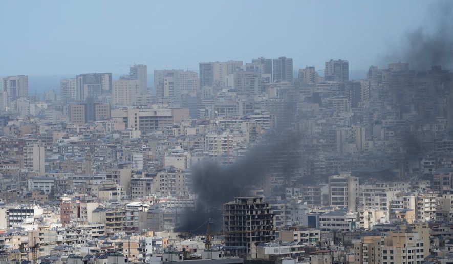 Smoke rises following an Israeli airstrike in Dahiyeh, Beirut's southern suburbs, Lebanon, Monday, March 30, 2026. (AP Photo/Bilal Hussein)