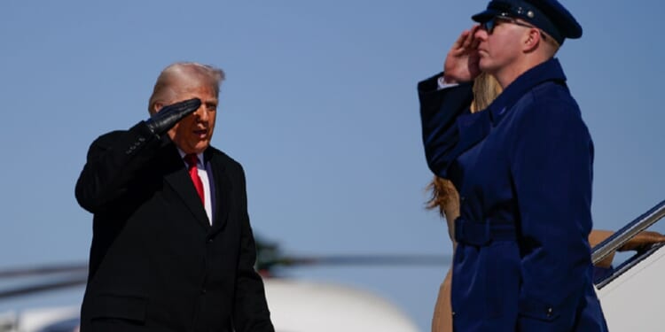 President Donald Trump salutes his military guard while boarding Air Force One in a Feb. 13 file photo.