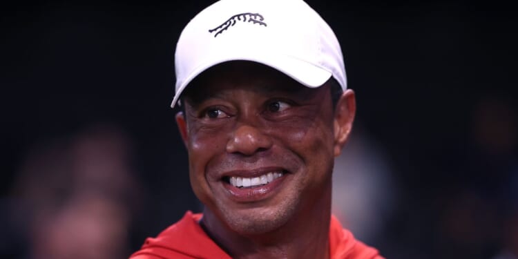 Tiger Woods smiles at a golf match at SoFi Center in Palm Beach Gardens, Florida, on March 23, 2026.