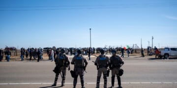 Texas State Troopers secure the area after dispersing a crowd protesting Immigration and Customs Enforcement at the South Texas Family Residential Center on Jan. 28, 2026, in Dilley, Texas.