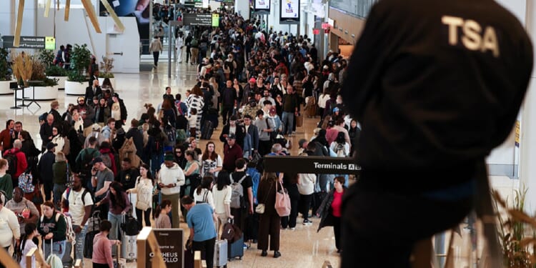 Huge lines of passengers clog New York's LaGuardia airport on Sunday,