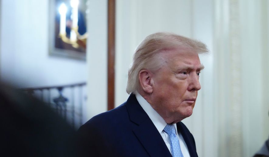 President Donald Trump arriving to speak at the Commander-in-Chief's Trophy presentation with the Navy Midshipmen football team in the East Room of the White House, Friday, March 20, 2026, in Washington. (AP Photo/Julia Demaree Nikhinson)