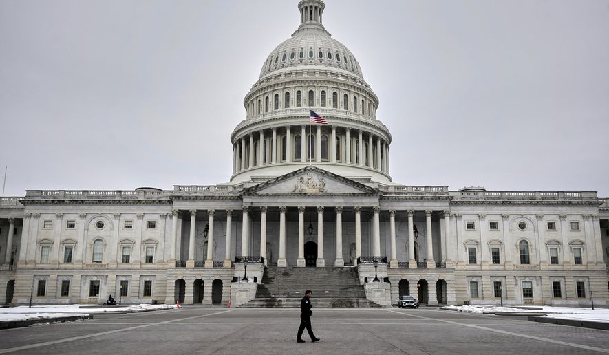A U.S. Capitol Police officer patrols on the East Front of the U.S. Capitol, Friday, Feb. 6, 2026, in Washington. (AP Photo/Rahmat Gul) ** FILE **