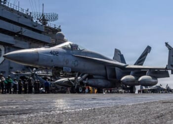 In this handout released by the U.S. Navy, an F/A-18E Super Hornet, attached to Strike Fighter Squadron (VFA) 151, taxis the flight deck of the Nimitz-class aircraft carrier USS Abraham Lincoln (CVN 72) in support of Operation Epic Fury on March 2, 2026.