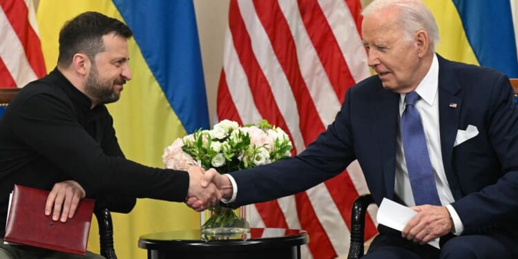 Ukrainian President Volodymyr Zelenskyy, left, shakes hands with then-Ppresident Joe Biden on June 7, 2024, during a bilateral meeting in Paris.