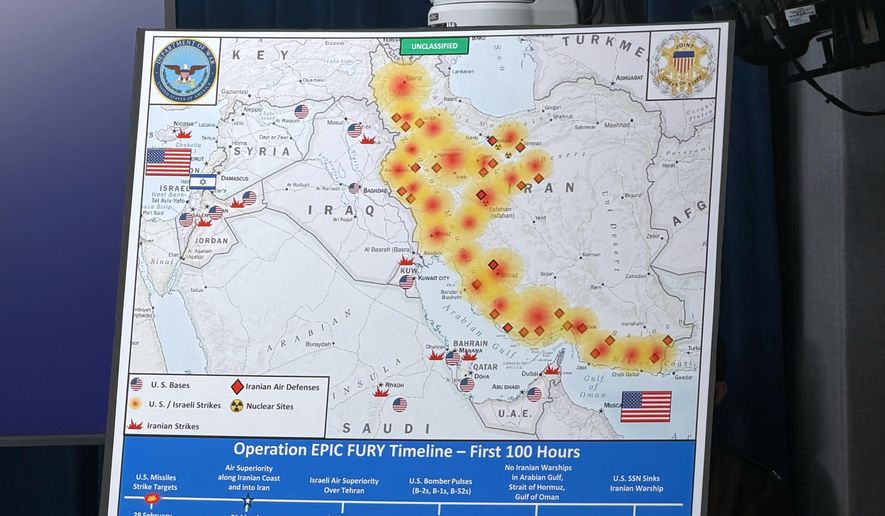A Department of Defense map titled, "Operation EPIC FURY Timeline — First 100 Hours," is displayed during a news conference with Defense Secretary Pete Hegseth and Chairman of the Joint Chiefs of Staff Gen. Dan Caine, at the Pentagon, Wednesday, March 4, 2026, in Washington. (AP Photo/Konstantin Toropin)