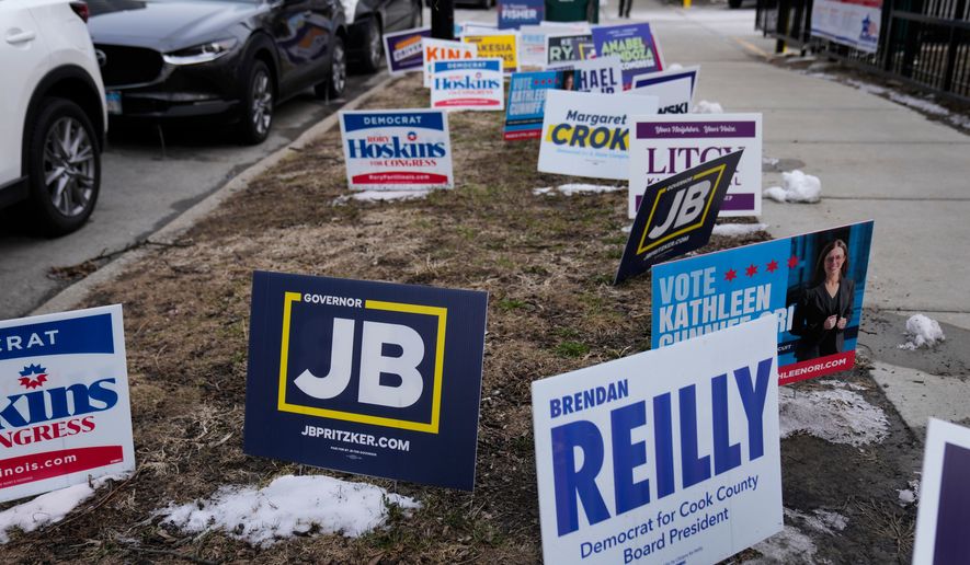 Signs are displayed outside of a polling location at Union Park during the Illinois primary election Tuesday, March 17, 2026, in Chicago. (AP Photo/Erin Hooley)