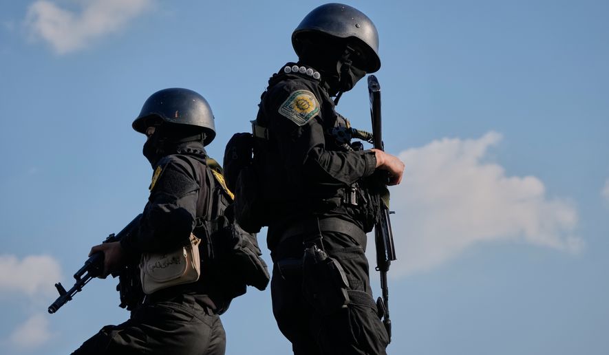 Iranian police special forces stand guard during a funeral procession for Alireza Tangsiri, head of Iran's Islamic Revolutionary Guard Corps Navy, and others killed in Israeli strikes in late March, in Tehran, Iran, Wednesday, April 1, 2026. (AP Photo/Vahid Salemi)