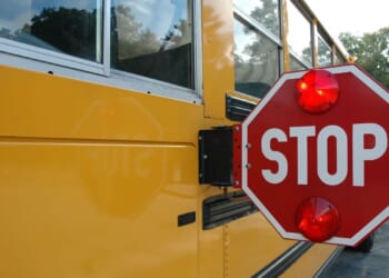 Train clips school bus with kids aboard; driver faces charges