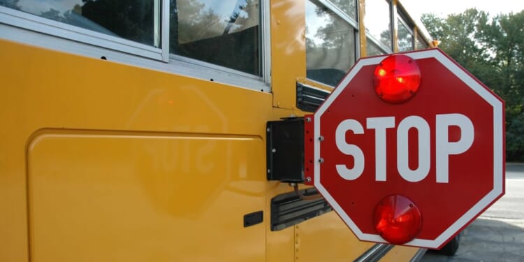 Train clips school bus with kids aboard; driver faces charges
