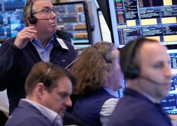 Wall Street holds near its record high even as oil prices climb