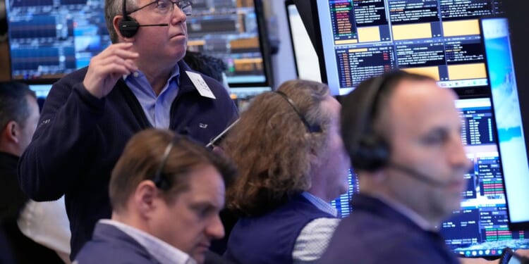 Wall Street holds near its record high even as oil prices climb