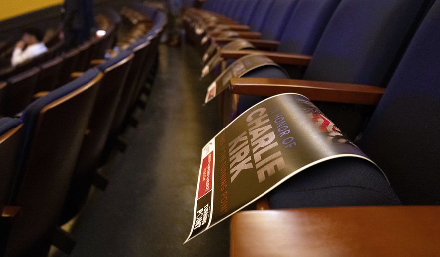 Posters with Charlie Kirk's image are placed on seats for attendees take home at The Turning Point Tour, Thursday, April 2, 2026, in Washington. (AP Photo/Tallulah Brown Van Zee)