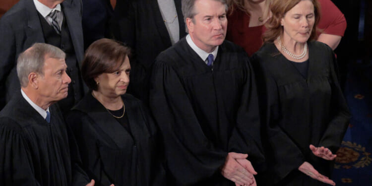 WASHINGTON, DC - FEBRUARY 24: U.S. Supreme Court Chief Justice John Roberts and Associate Justices Elena Kagan, Brett Kavanaugh and Amy Coney Barrett applaud at the conclusion of President Donald Trump's State of the Union address during a joint session of Congress at the Capitol on February 24, 2026, in Washington, DC. Trump delivered his address days after the Supreme Court struck down the administration's tariff strategy and amid a U.S. military buildup in the Persian Gulf threatening Iran. (Photo by Chip Somodevilla/Getty Images)