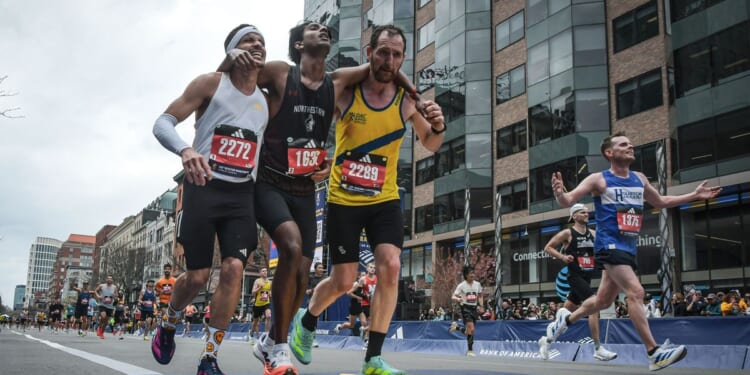 Runners were struggling to finish Boston Marathon when competitors came along and helped them across