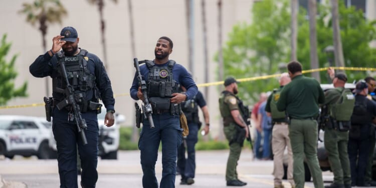 Authorities arrest one person and search for another, following deadly shooting at mall in Louisiana