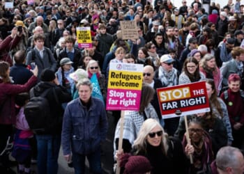 Stand Up To Racism protesters gather in outside on March 28, 2026.
